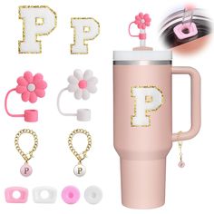 a pink coffee cup with the letter p on it next to other accessories and items