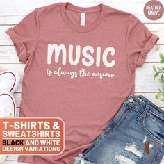 This stylish T-shirt and cozy sweatshirt feature the uplifting message "Music is always the answer". Perfect for music lovers, this comfortable apparel is great for casual wear or as a thoughtful gift. Let everyone know that music is your ultimate solution with this unique design! ❤️ HOW TO ORDER ❤️ 1. Check out all the photos for sizing and color options.📏 2. Choose your perfect size and color from the drop-down menus!✨ 3. Click "ADD TO CART" and feel free to add as many as you wish! 🛒 4. Hit "PROCEED TO CHECKOUT" and get ready to enjoy your awesome purchase! We will process your order and it will be ready for shipment in 1-5 days!🚀 5. Want this design on another product or want to make slight alterations? Check the bottom of the description.✨ 🎁 UNISEX T-SHIRTS 🎁 Brand: Bella Canas 3 Music-themed Slogan Crew Neck Top, Music-themed Slogan Tops With Crew Neck, Music-themed Cotton Tops With Slogan, Music-themed Slogan Top With Crew Neck, Music-themed Cotton Slogan Tops, Music-themed Cotton Sweatshirt With Letter Print, Music-themed Cotton Letter Print Sweatshirt, Music-themed Letter Print Cotton Sweatshirt, Music-themed Cotton Crew Neck Sweatshirt