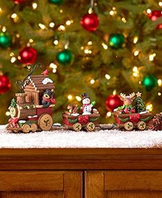 a christmas scene with santa's sleigh and reindeers in front of a tree