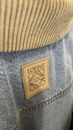 a label on the back of a pair of jeans that say love is in the air