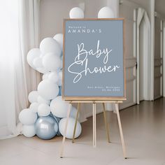 a baby shower sign in front of balloons