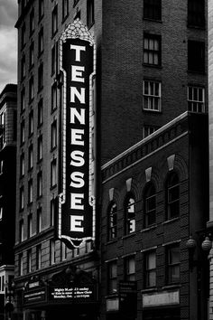 an old theater sign on the side of a building