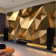 a modern living room with gold and black wallpaper, large television set and coffee table