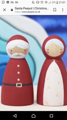 an image of santa and mrs claus dolls on the same item as they are in front of a blue background