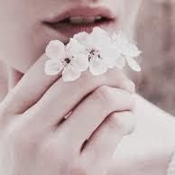 a close up of a person holding flowers in their hand