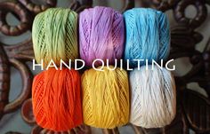 four skeins of multicolored yarn with the words hand quilting on it