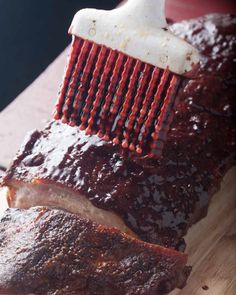 a piece of meat is being brushed with a brush