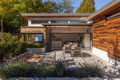 an outdoor living area with wooden walls and furniture