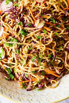 a white plate topped with noodles and veggies