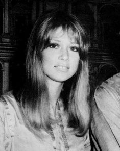 an old black and white photo of a woman sitting next to a man in a suit