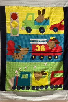 a child's wall hanging made to look like a train with animals on it