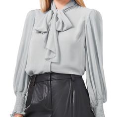 Cute And Classy Gauzy Blouse By Vince Camuto! Light Gray. Long Sleeve With Ruched Cuffs. Mock Neck With Tie Accent. Button Up. Fully Lined Bodice With Sheer Sleeves. Size Extra Large. Nwt! -Pit To Pit: 23” -Waist: 23” -Length: 22.5” 6.24 Royal Blue Blouse, Colorful Blouses, Floral Print Tunic, Gold Blouse, Front Tie Shirt, Leopard Print Blouse, Gathered Sleeves, White Halter Maxi Dress, Womens Long Sleeve Shirts