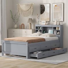 a bed with drawers underneath it in a room