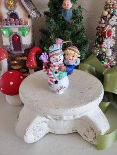 a white table topped with a snowman figurine