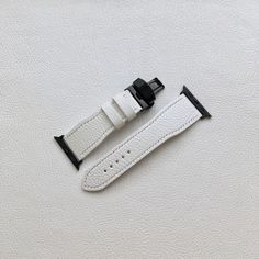 A simple Apple Watch strap. It is made from the finest Italian goat leather. The leather itself is durable and has unique texture and color.  Edges are very smooth - carefully polished, painted and waxed so it's comfortable on wrist.  There's also leather lining.  Watch strap comes with  * butterfly clasp * 2 keepers * adapters Fully handcrafted / 100% unplugged  Length of shorter part - 70 mm Length of longer part - 110 mm *without adapters Lug width - 22mm Buckle width - 20mm  Thickness - 2,7mm Hardware - Stainless Steel / Black Leather Color - White Leather Type - Goat leather Lining - White goat leather Item is ready to ship so You don't need to wait! White Leather Strap Watch Bands For Gift, Luxury White Leather Watch Band, Modern White Leather Apple Watch Band, Adjustable Silver Leather Watch Band, White Apple Watch, Luxury White Leather Strap Watch Band, Leather Phone Cover, Iwatch Apple, Bracelet Apple Watch