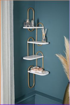 a shelf with candles and other items on it in a room that has blue walls