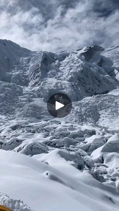 a man riding skis down the side of a snow covered mountain next to a tent