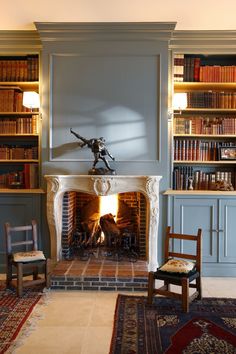 a living room with a fire place and bookshelves filled with lots of books