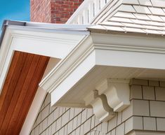 the corner of a house with a white gutter cover on it's side