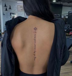 the back of a woman's neck with an inscription on it that reads,