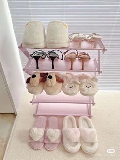 there is a pink shelf with many pairs of shoes on it and slippers hanging from the top