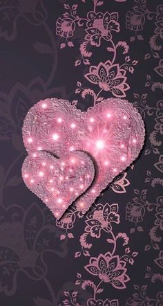 two pink hearts with lights in the middle