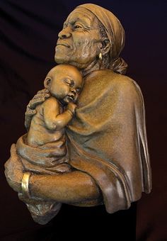 a statue of an old woman holding a baby