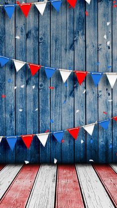 red, white and blue bunting on wooden planks