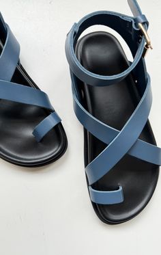 The perfect summer walking shoe to go with your Two look! These leather sandals are made in Italy and just the perfect thing to run around town in this summer. Featuring a  criss cross and toe strap to hold your foot in as you explore. Size guide: 36/6  37/7  38/8  39/9  40/10  41/11 Half sizes should size down Color: Blue Shoes Sandals, Blue Leather Sandals, Color Jeans, Criss Cross Sandals, Caged Sandals, Black Tank Dress, Black Aviators, Neon Purple, Footwear Design Women