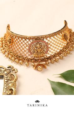 Indulge in the allure of tradition with the Sampada Antique Choker Set from Tarinika. This remarkable jewelry set is designed to transport you to a world of regal elegance and timeless beauty, showcasing the rich heritage of antique craftsmanship. Antique Choker, Goddess Laxmi, Regal Elegance, Temple Jewelry, The Ivy, Choker Set, Temple Jewellery, The Goddess, Cz Stone