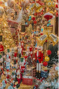 many christmas decorations are on display in a store