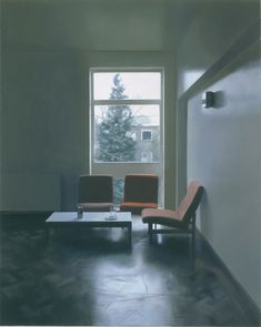 an empty room with two chairs and a coffee table