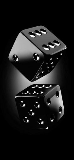 two black dices with holes in the middle on a black background, one is upside down