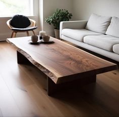 a wooden table sitting in front of a white couch