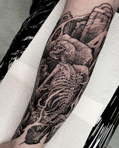 a man's arm with a black and white tattoo on it