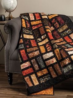 a couch with a quilt on top of it