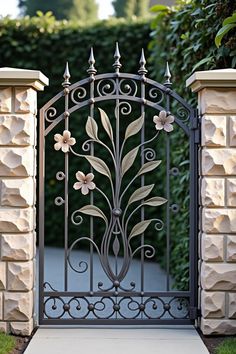 an iron gate with flowers on it