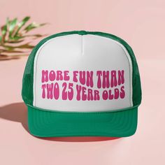 a green and white trucker hat with the words more fun than two years old on it