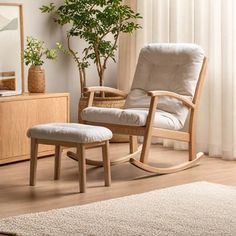 a rocking chair and ottoman in a living room with a potted plant on the side