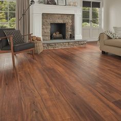 a living room with wood floors and a fireplace