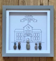 a white frame with some rocks in front of it