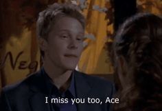 a man in a suit and tie talking to another person with the caption i miss you too, ace