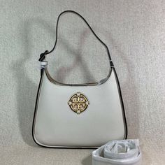 Brand New Never Been Carried Small Convertible Miller Hobo By Tory Burch. This Bag Is Made Of Ivory Genuine Leather Dimensions: 7.6" Wide X 11.2" Tall Center X 2.4" Deep. Wear As A Shoulder Bag With 7.2" Strap Drop Or Crossbody Bag With Extended 22.5" Drop Strap. Comes With Adjustable And Detachable Long Strap. Hidden Magnetic Button Closure Leather Logo Interior: 1 Zippered And 1 Slip Pocket Micro Fiber Lining. Brass Tone Metalware. High-end White Shoulder Bag For Travel, Luxury White Hobo Bag, High-end Cream Shoulder Bag, Luxury Beige Hobo Bag With Dust Bag, Luxury Beige Shoulder Bag With Silver-tone Hardware, Timeless Beige Shoulder Bag With Silver-tone Hardware, White Crossbody Shoulder Bag With Silver-tone Hardware, High-end White Bags With Detachable Handle, High-end White Bag With Palladium Hardware