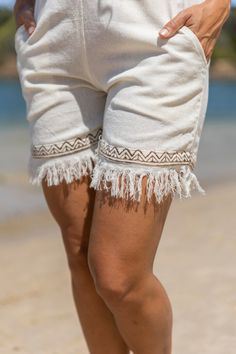 The Nala Shorts seamlessly blend comfort and bohemian style. Crafted from 100% cotton and natural fibers, these shorts feature a unique tribal blockprint, adding an artisanal touch to your wardrobe. The hand-made design exudes a free-spirited charm, capturing the essence of festival fashion. Embrace the carefree vibes with frayed edges, giving these shorts an effortlessly stylish and relaxed look. Whether you're dancing under the festival lights or exploring a bohemian paradise, these shorts are Bohemian Bottoms With Built-in Shorts For Vacation, Beige Cotton Beachwear Bottoms, Bohemian Style Short Bottoms For Beach Season, Bohemian Short Bottoms For Beach Season, Bohemian Short Bottoms For Beach, Bohemian Beach Bottoms Short Length, Bohemian Beach Shorts For Beach Season, Bohemian Short-length Bottoms For Beach, Bohemian Short Length Bottoms For Beach