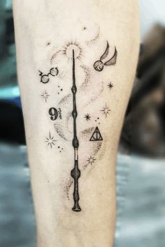 a tattoo on the leg of a person with a clock and other things in it