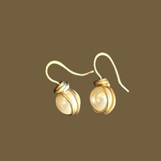 Elevate any look with our Hand Wrapped Swarovski Pearl Earrings. Perfect for brides and bridesmaids, these drop earrings blend simple gold with timeless elegance. Ideal for special occasions or everyday wear, they make a thoughtful gift. Capture the essence of sophistication with these stunning earrings. Elegant Wire Wrapped Wrap Earrings As Gift, Elegant Wedding Wrap Earrings With Ear Wire, Adjustable Wrap Earrings For Wedding, Elegant Handmade White Wrap Earrings, Elegant Wire Wrapped Earrings For Formal Occasions, Wire Wrapped Drop Earrings For Wedding, Elegant Adjustable White Wrap Earrings, Elegant White Adjustable Wrap Earrings, Formal Wire Wrapped Drop Earrings