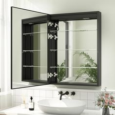 a bathroom sink sitting under a mirror next to a window