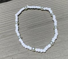 anklet, made with white seed beads, and fake pearls White Pearl Beaded Bracelets, White Round Bead Anklets For Summer, White Round Beads Anklet For Summer, Adjustable Beaded Pearl Anklets, White Pearl Bracelet With Charm For Beach, White Beaded Pearl Bracelet For Beach, White Pearl Anklets For Summer, Summer White Pearl Anklets, White Beaded Chain Anklets As Gift