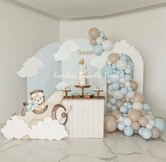 a baby's first birthday party with balloons, cake and teddy bear in car