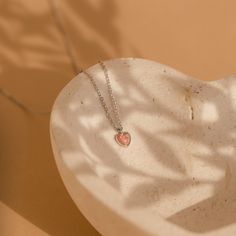 Celebrate the delicate beauty of our Pink Opal Heart Necklace, a charming and minimalistic accessory. Crafted with a heart-shaped pink opal, this dainty necklace not only adds a touch of elegance to your style but also showcases the unique properties of opal, making it a meaningful addition to your collection. Material: High Quality Solid 925 Sterling Silver Finish: Sterling Silver ∙ 18K Gold Featuring a ~5x5mm Pink Opal Heart Charm on an adjustable necklace from 16 to 18 inches Part of our Opal Opal Heart Necklace, Initial Tag Necklace, Fingerprint Necklace, Sideways Initial Necklace, Diamond Huggies, Minimalist Accessories, Delicate Beauty, Flower Studs, Adjustable Necklace